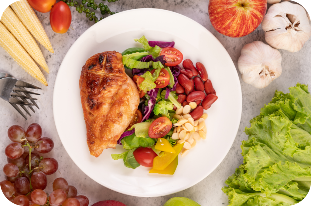 chicken steak topped with white sesame peas tomatoes broccoli pumpkin white plate modified 1
